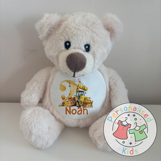 This adorable personalised teddy bear makes the perfect gift for little construction fans! The soft plush bear features a printed design with a yellow digger, crane, and traffic cones, along with your child’s name and age. A thoughtful keepsake that can be paired with our matching clothing range for a complete birthday gift set.