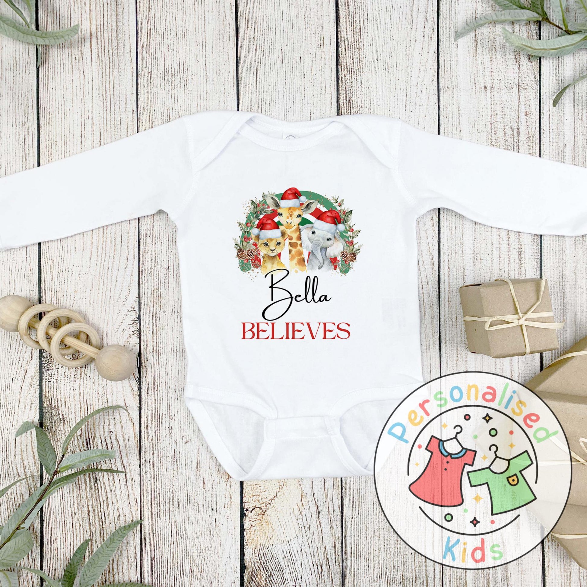 Make this Christmas even more magical with our Personalised Christmas onesie pj – perfect for the whole family! These white cotton bay onsies feature an adorable festive safari animal design, complete with your chosen name and the word &quot;BELIEVES&quot; printed underneath in bold red. Whether you&#39;re matching on Christmas morning, heading to a festive event, or capturing the perfect holiday photo, these cosy onsies are the perfect touch of personalised Christmas cheer.