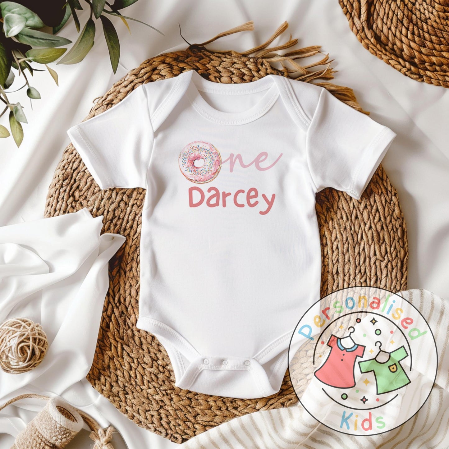 Make their first birthday extra sweet with this adorable personalised donut birthday outfit. Featuring the word “One” with a colourful sprinkle donut design in place of the “O”, and your child’s name personalised underneath, this outfit is perfect for birthday celebrations, cake smash photos, or as a keepsake to treasure.