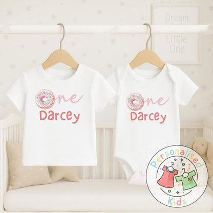 Make their first birthday extra sweet with this adorable personalised donut birthday outfit. Featuring the word “One” with a colourful sprinkle donut design in place of the “O”, and your child’s name personalised underneath, this outfit is perfect for birthday celebrations, cake smash photos, or as a keepsake to treasure.