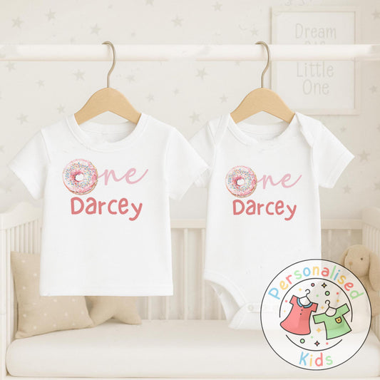 Make their first birthday extra sweet with this adorable personalised donut birthday outfit. Featuring the word “One” with a colourful sprinkle donut design in place of the “O”, and your child’s name personalised underneath, this outfit is perfect for birthday celebrations, cake smash photos, or as a keepsake to treasure.