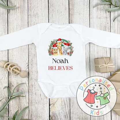 Make this Christmas even more magical with our Personalised Christmas onesie pj – perfect for the whole family! These white cotton bay onsies feature an adorable festive safari animal design, complete with your chosen name and the word &quot;BELIEVES&quot; printed underneath in bold red. Whether you&#39;re matching on Christmas morning, heading to a festive event, or capturing the perfect holiday photo, these cosy onsies are the perfect touch of personalised Christmas cheer.