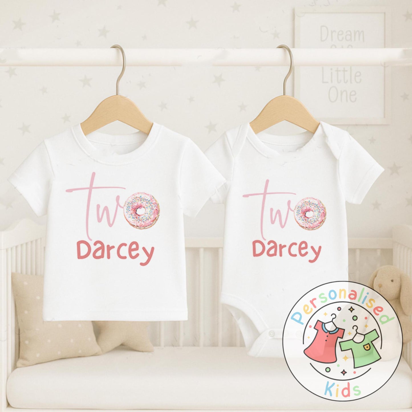 Make their 2nd birthday even sweeter with this adorable personalised donut birthday outfit! Featuring the word “Two” with a sprinkle donut design and your child’s name underneath, this cute top or baby grow is the perfect choice for a birthday celebration, cake smash, or as a special keepsake gift.