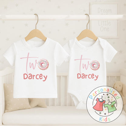 Make their 2nd birthday even sweeter with this adorable personalised donut birthday outfit! Featuring the word “Two” with a sprinkle donut design and your child’s name underneath, this cute top or baby grow is the perfect choice for a birthday celebration, cake smash, or as a special keepsake gift.