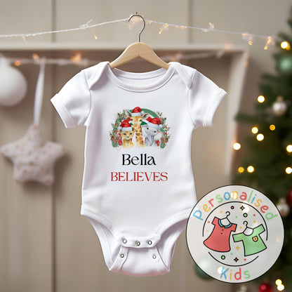 Make this Christmas even more magical with our Personalised Christmas onesie pj – perfect for the whole family! These white cotton bay onsies feature an adorable festive safari animal design, complete with your chosen name and the word &quot;BELIEVES&quot; printed underneath in bold red. Whether you&#39;re matching on Christmas morning, heading to a festive event, or capturing the perfect holiday photo, these cosy onsies are the perfect touch of personalised Christmas cheer.