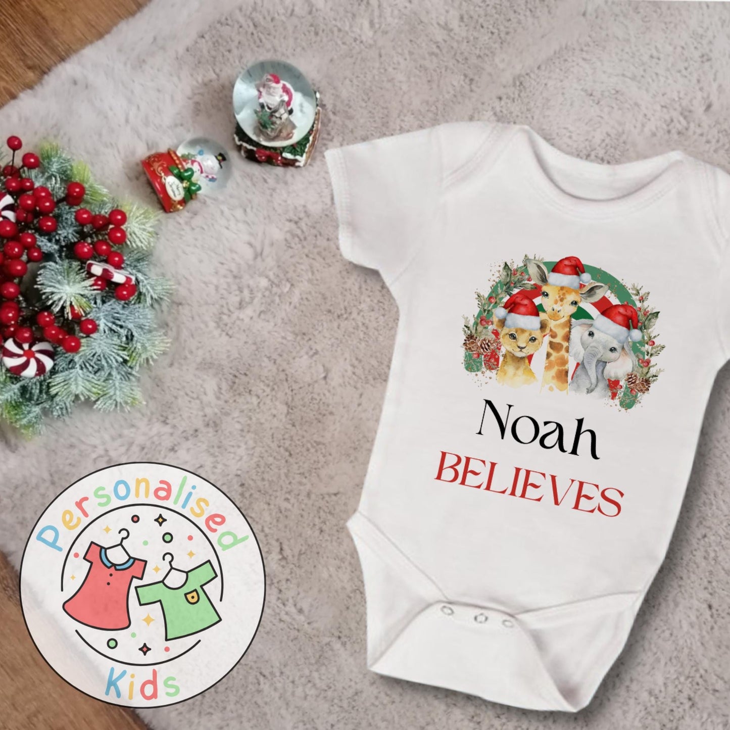 Make this Christmas even more magical with our Personalised Christmas onesie pj – perfect for the whole family! These white cotton bay onsies feature an adorable festive safari animal design, complete with your chosen name and the word &quot;BELIEVES&quot; printed underneath in bold red. Whether you&#39;re matching on Christmas morning, heading to a festive event, or capturing the perfect holiday photo, these cosy onsies are the perfect touch of personalised Christmas cheer.