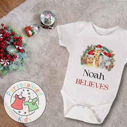 Make this Christmas even more magical with our Personalised Christmas onesie pj – perfect for the whole family! These white cotton bay onsies feature an adorable festive safari animal design, complete with your chosen name and the word &quot;BELIEVES&quot; printed underneath in bold red. Whether you&#39;re matching on Christmas morning, heading to a festive event, or capturing the perfect holiday photo, these cosy onsies are the perfect touch of personalised Christmas cheer.