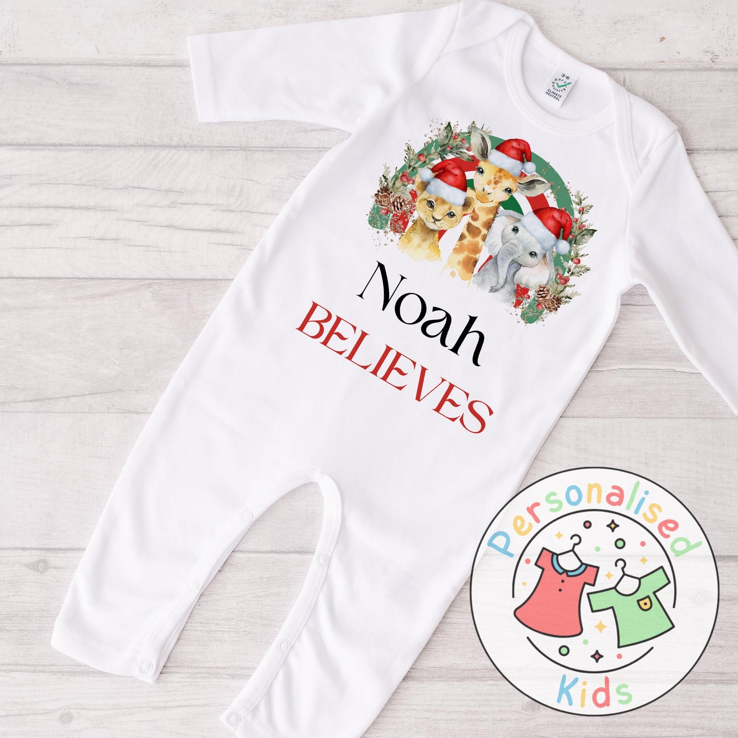 Make this Christmas even more magical with our Personalised Christmas onesie pj – perfect for the whole family! These white cotton bay onsies feature an adorable festive safari animal design, complete with your chosen name and the word &quot;BELIEVES&quot; printed underneath in bold red. Whether you&#39;re matching on Christmas morning, heading to a festive event, or capturing the perfect holiday photo, these cosy onsies are the perfect touch of personalised Christmas cheer.